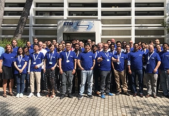 Group photo of participants in blue T-shirts