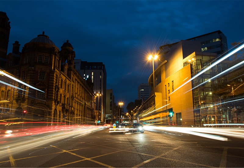 Cars driving by night with light beams