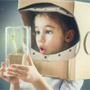 A child discovers with surprise that a plant has grown in a jar