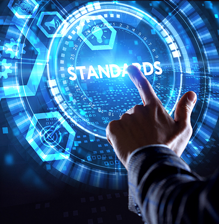 Finger pointing to a screen that reads "Standards"