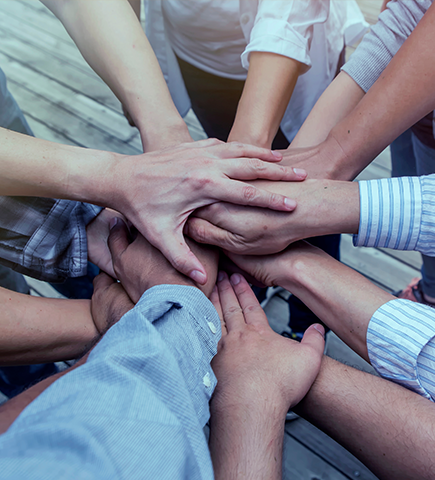 Groups of people with their hands together